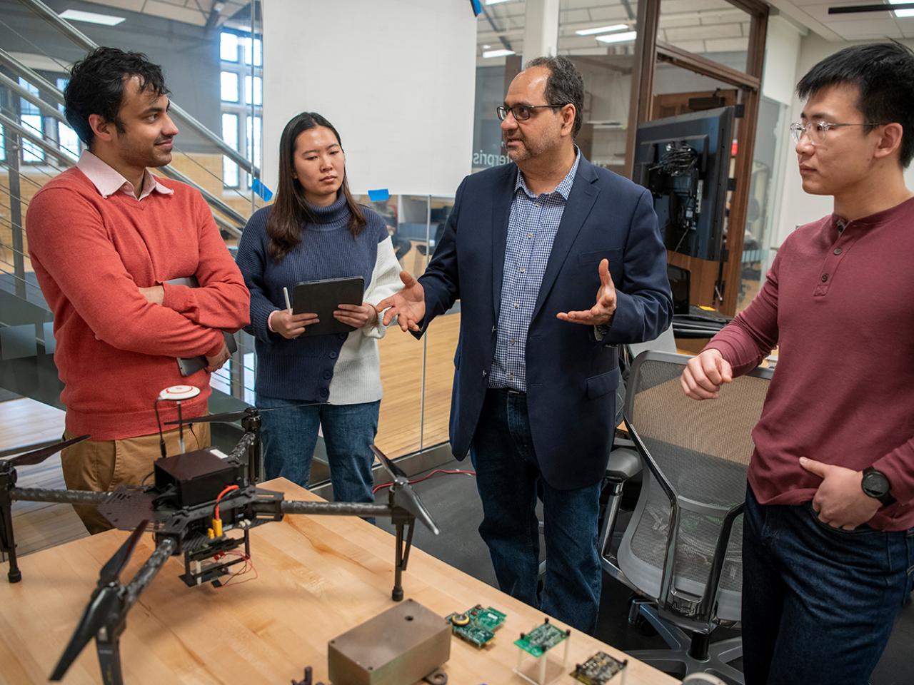 Computer Science and Engineering professor Ness Shroff with students from his research lab.