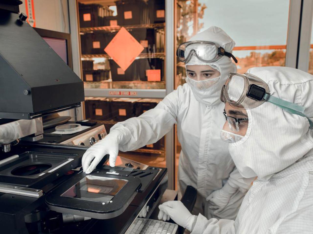 Two researchers examining technology at Institute for Materials and Manufacturing Research