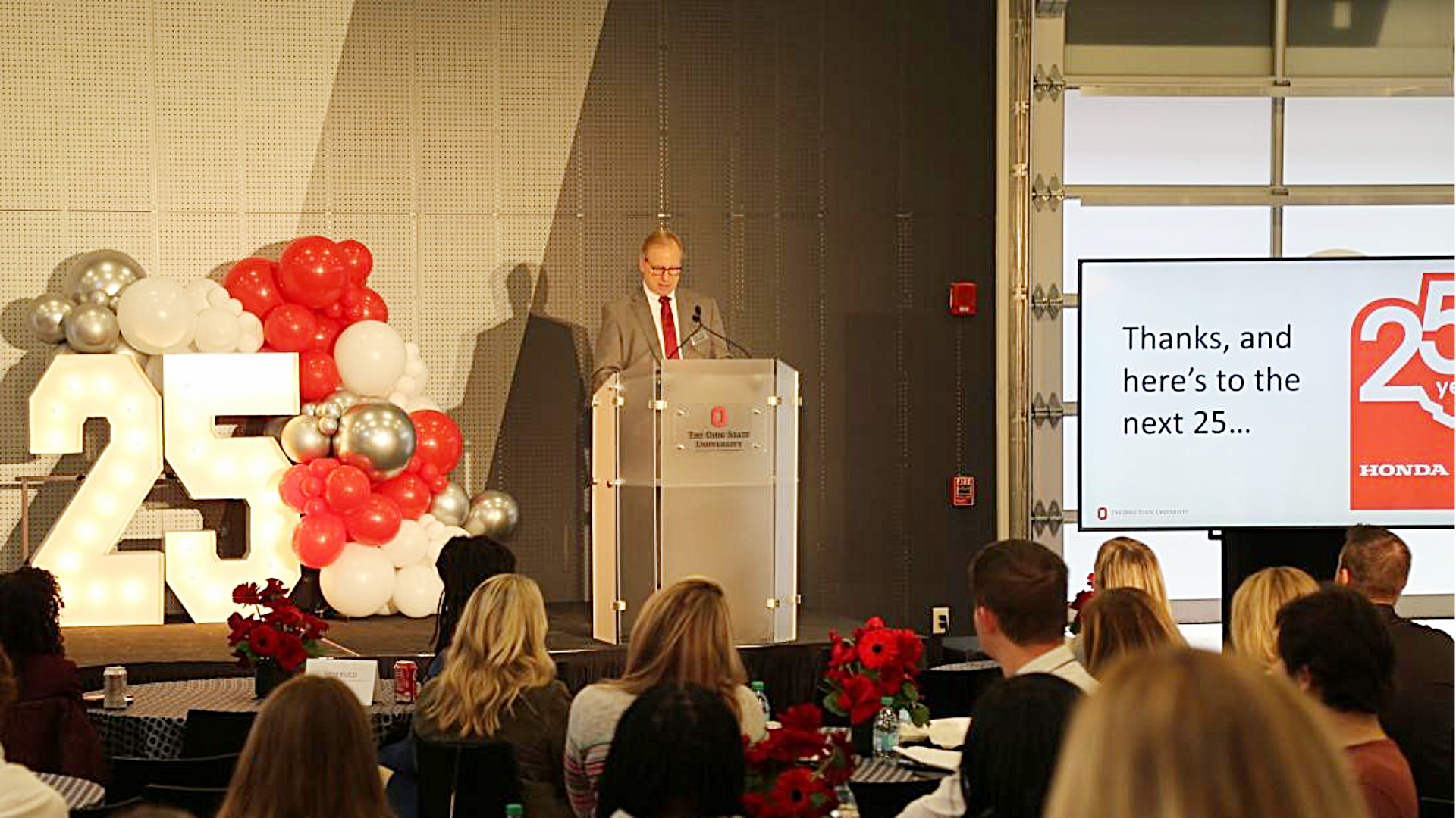 man speaking at podium