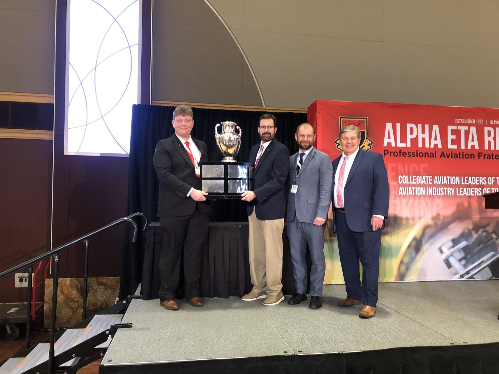 Wesley Holtz (left), Ohio State air transportation major; Blake Stringer, Center for Aviation Studies director; Brian Strzempowski, engineering education professor; and Bob Clement, Alpha Eta Rho president.