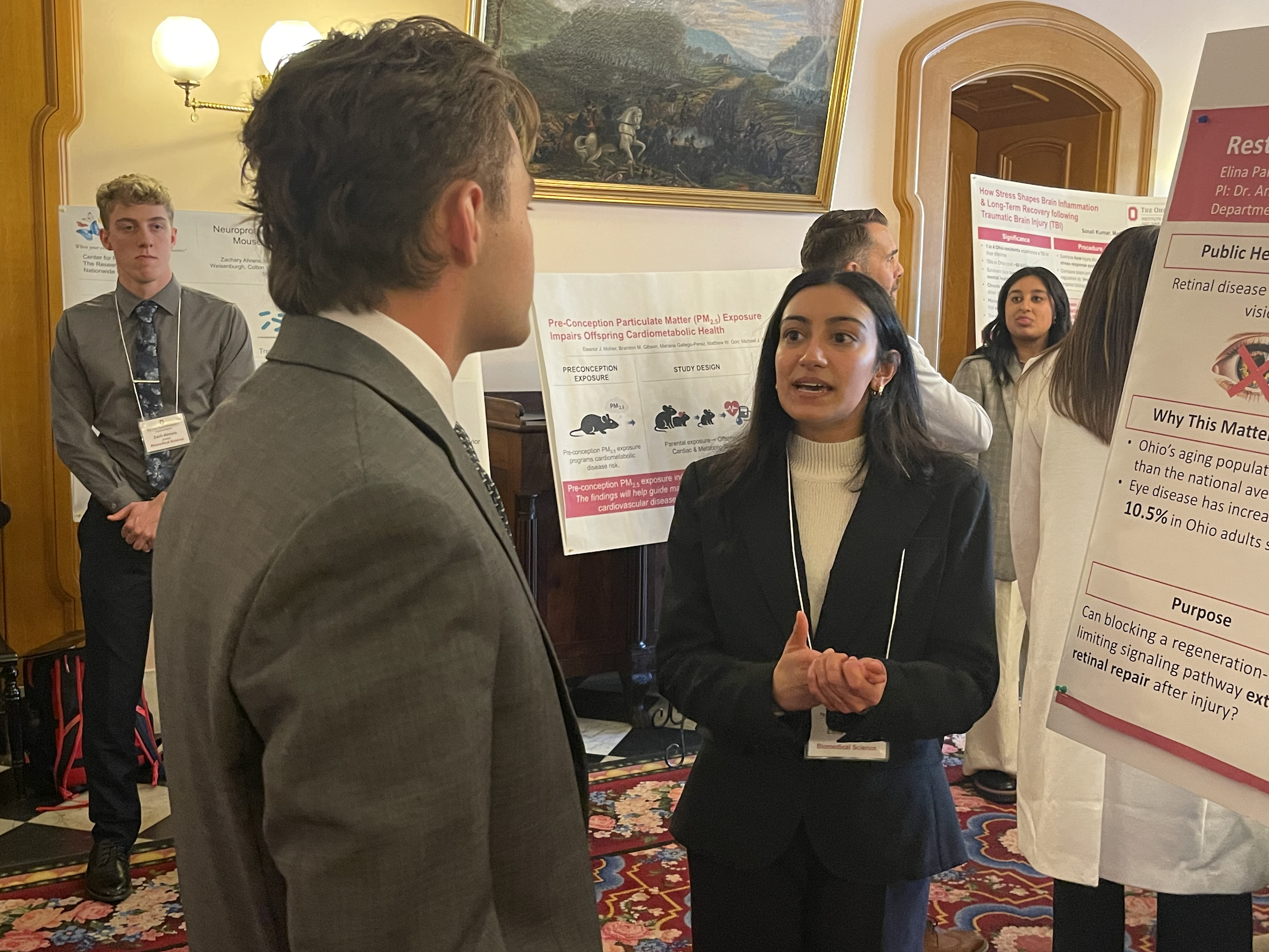 Elina Parekh, a junior from Mason, Ohio, presents her research during the event.