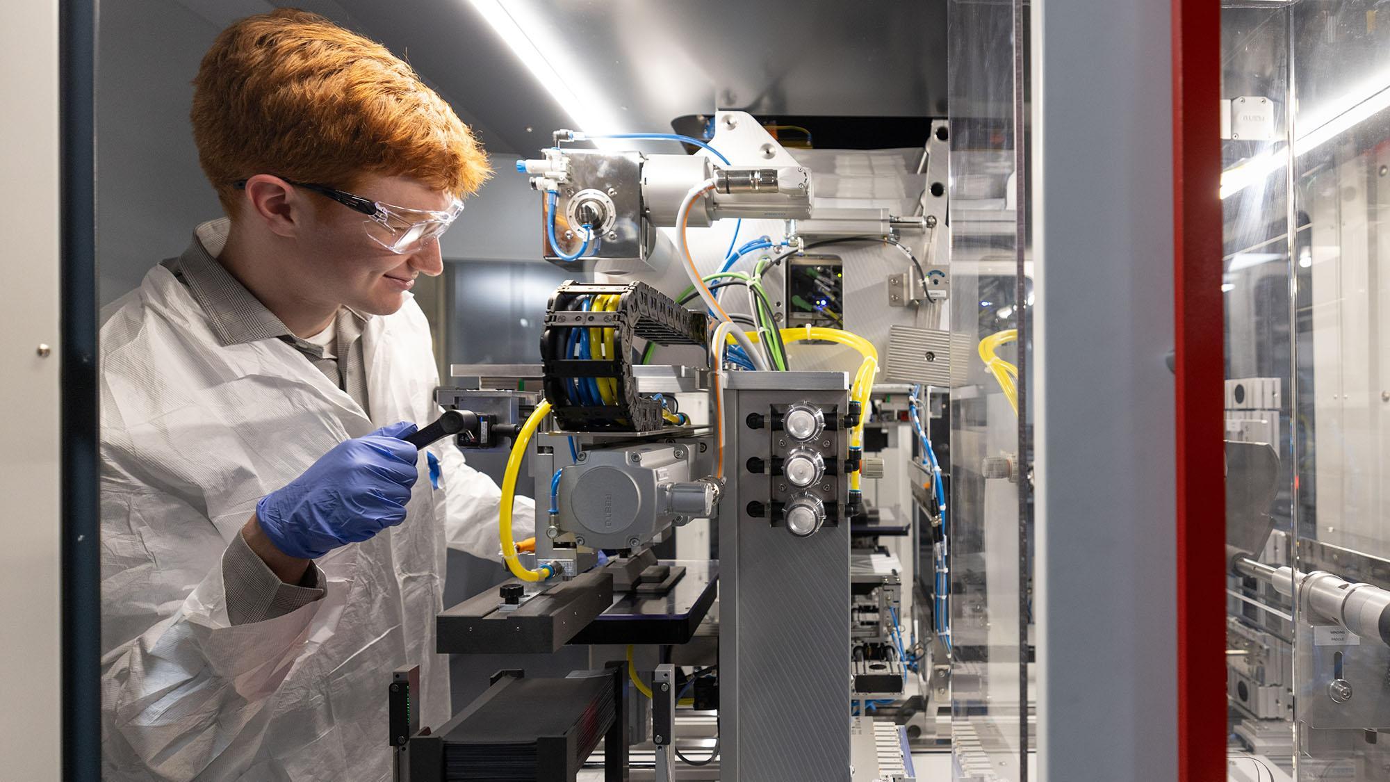 Ohio State engineering student Bennett Kolda works on a developmental battery at Ohio State's Battery Cell Research and Development Center. This year, Kolda was part of the inaugural cohort of the Bridging Academic Training Through Experiential Research and Innovation (BATTERI) program. The internship helped Kolda develop his knowledge of advanced battery manufacturing. (Jodi Miller)